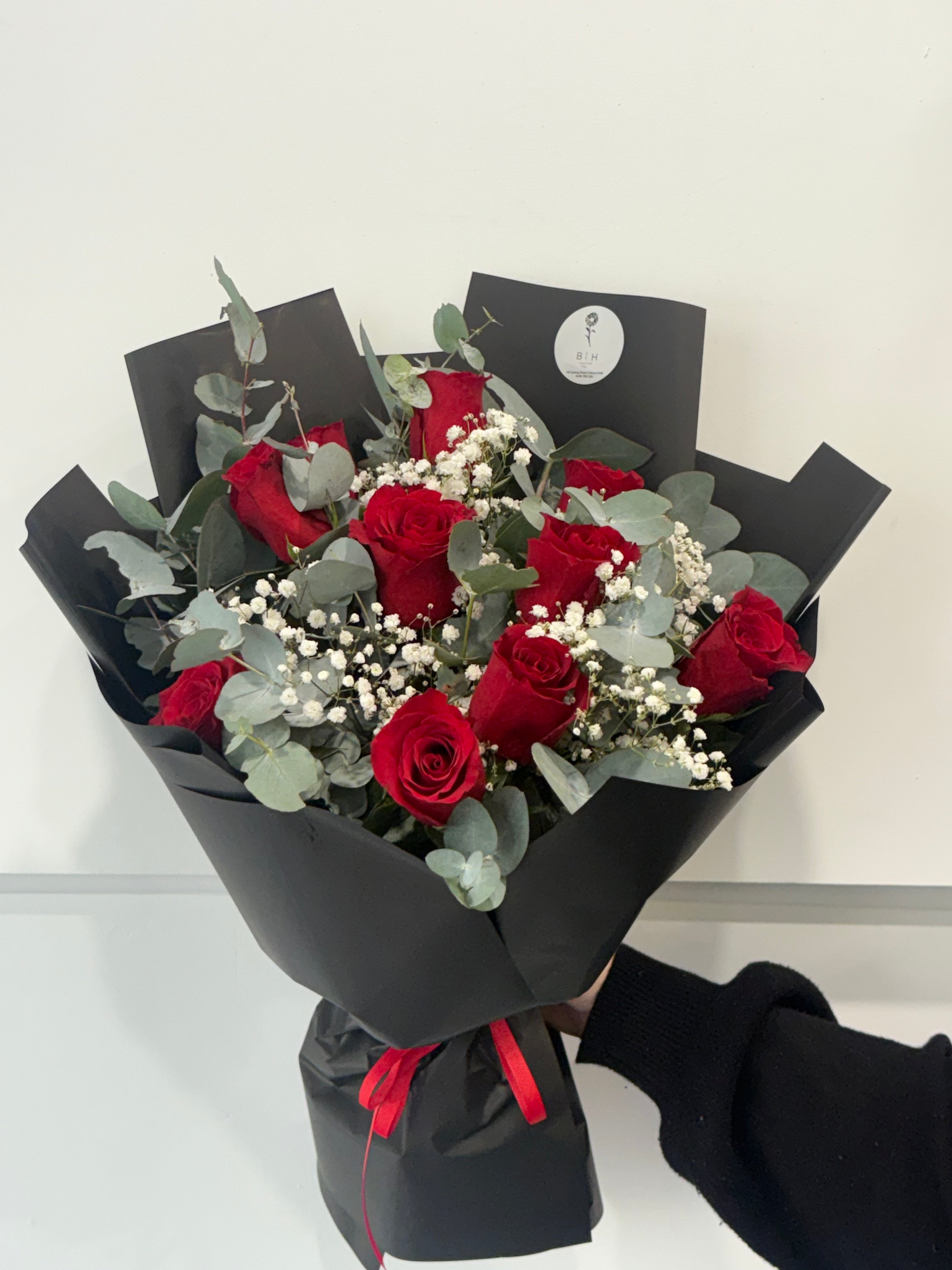 Red rose bouquet wrapped in black