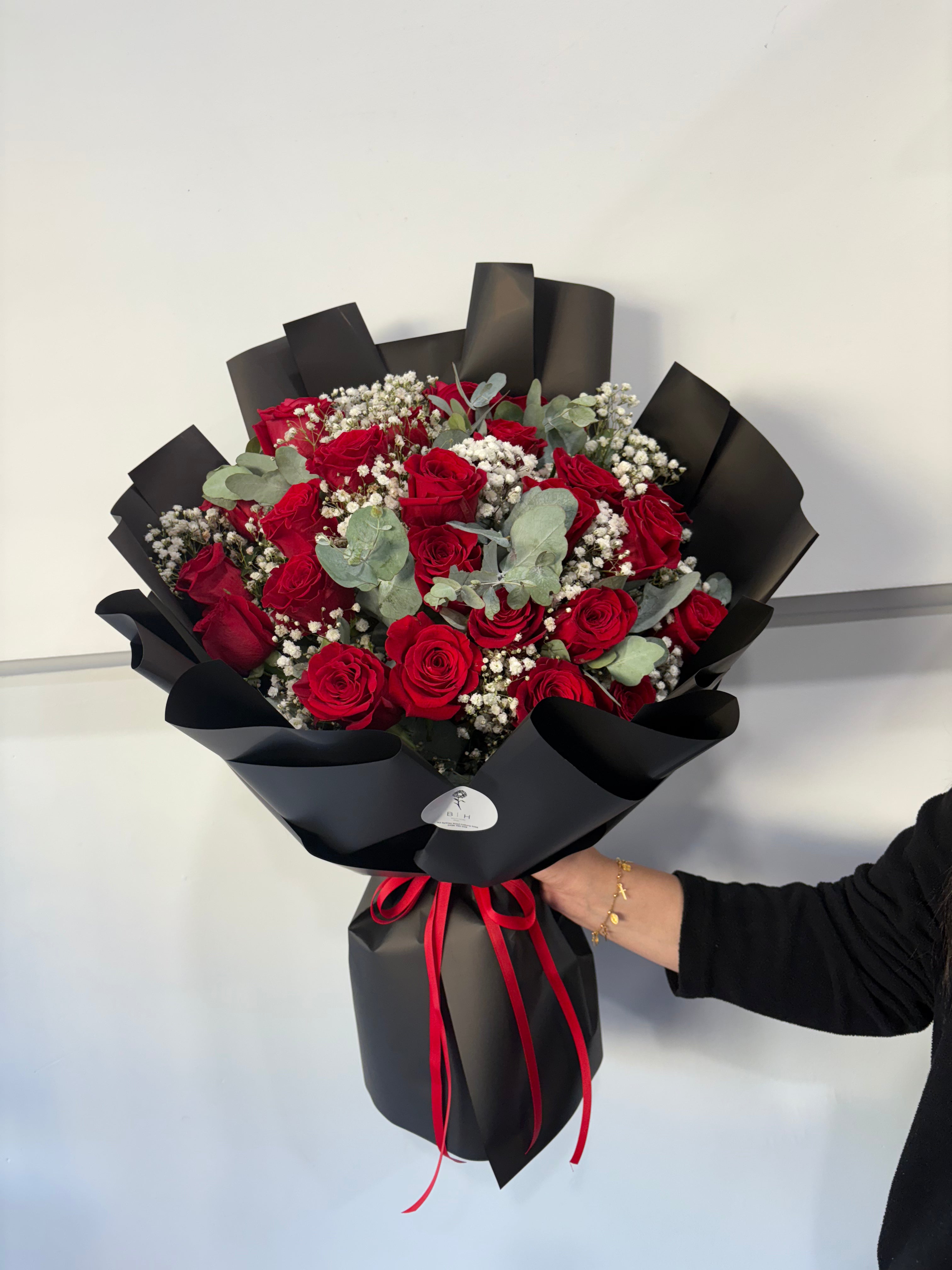 Red rose bouquet wrapped in black